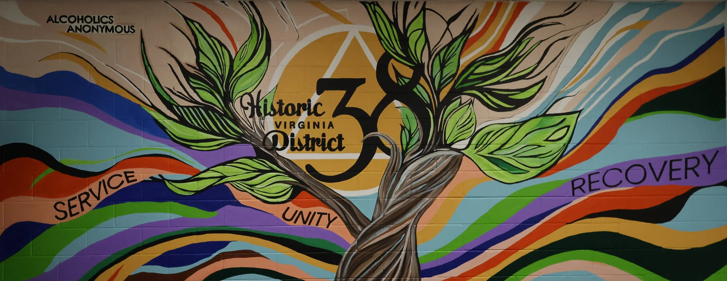 Colorful mural celebrating Virginia's 30th District with a tree, leaves, and words 'Service,' 'Unity,' and 'Recovery' displayed.