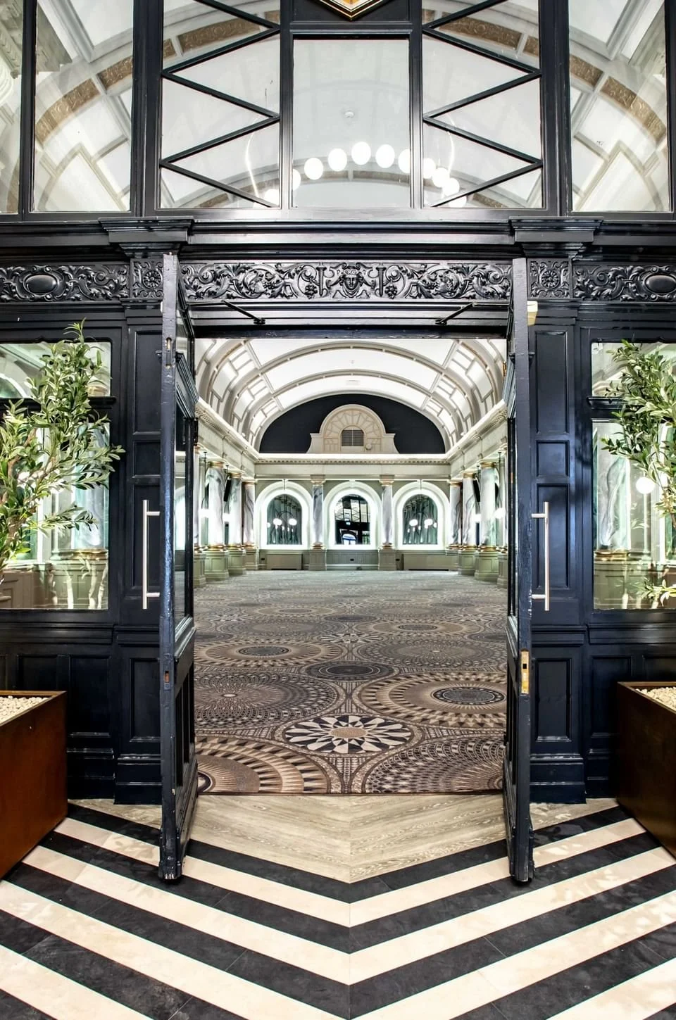 grand-entrance-to-the-spacious-event-hall-at-the-met-hotel-leeds-england-featuring-a-chevron-floor-and-a-historic-clock.jpg