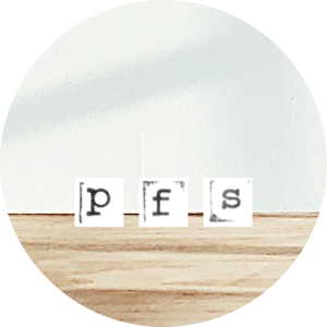 Three letter blocks spelling 'p', 'f', 's' on a wooden surface.