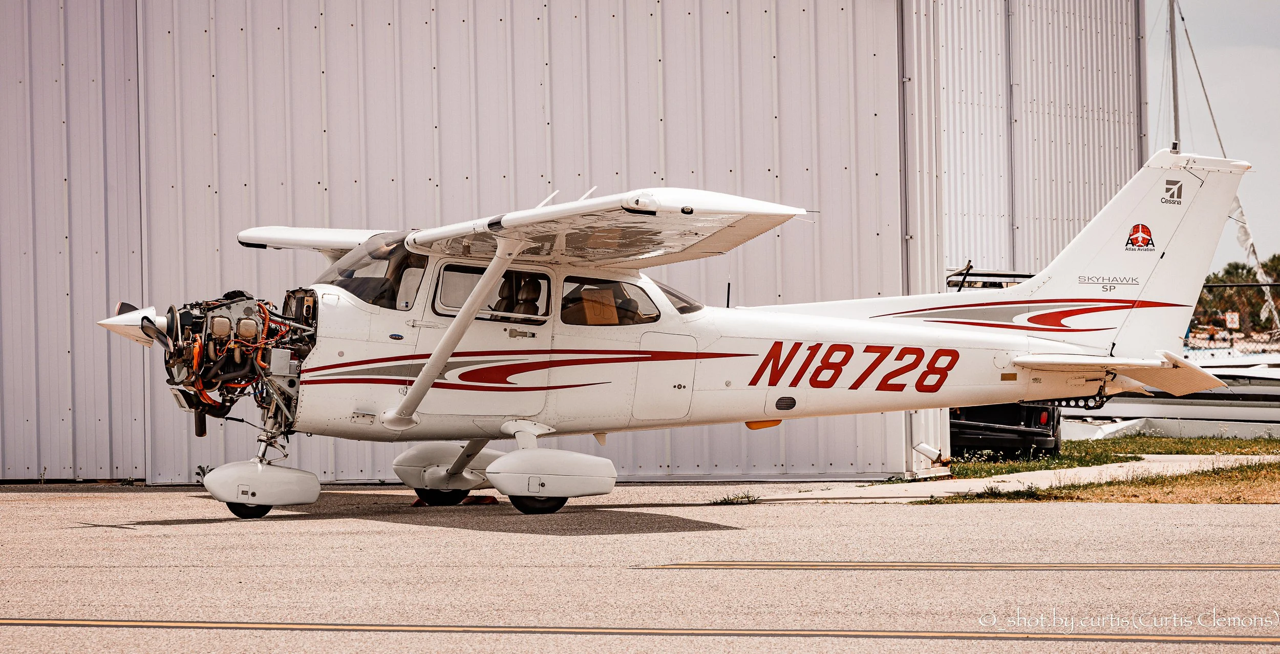 Cessna 172SP owned by Atlas Aviation without its engine cowling parked outside the maintenance hangar at KTPF (Peter O'Knight Airport)