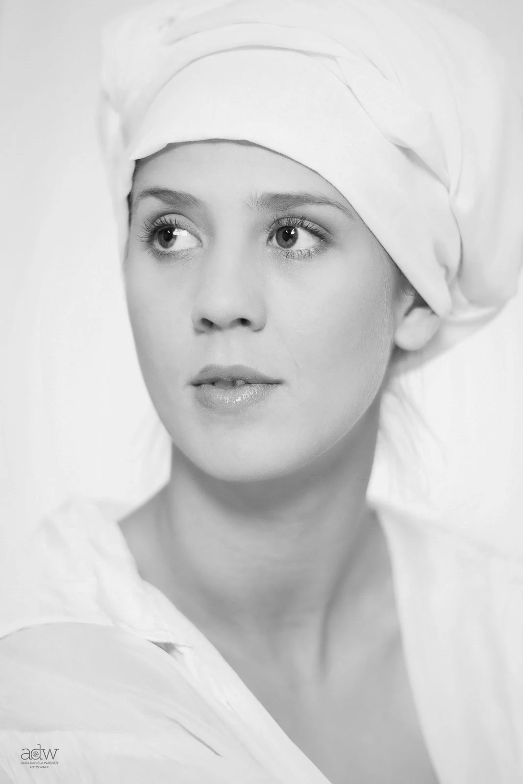 Black and white portrait of a woman with light skin, wearing a medical or chef's cap, looking slightly to her left with a neutral expression.