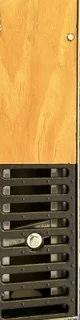 Close-up of a wooden door with a metal vent and a small keyhole.