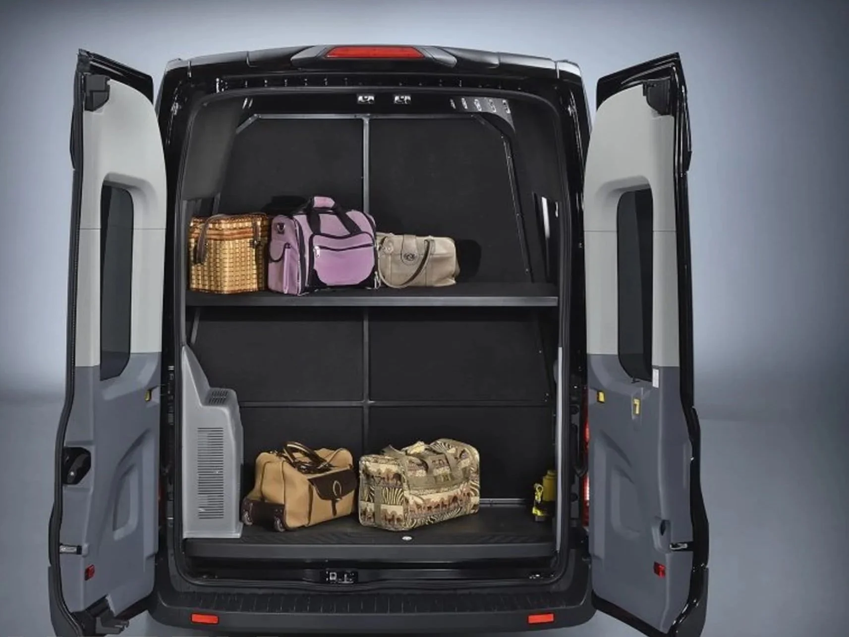 Open Ford Transit van with three shelves inside, holding various bags including a purple duffel bag, a beige purse, and patterned luggage.