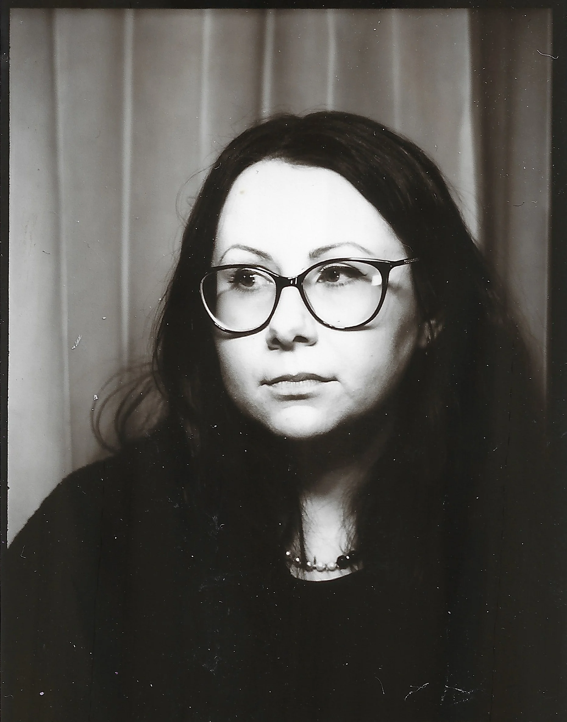 black and white portrait of woman in an old style photobooth