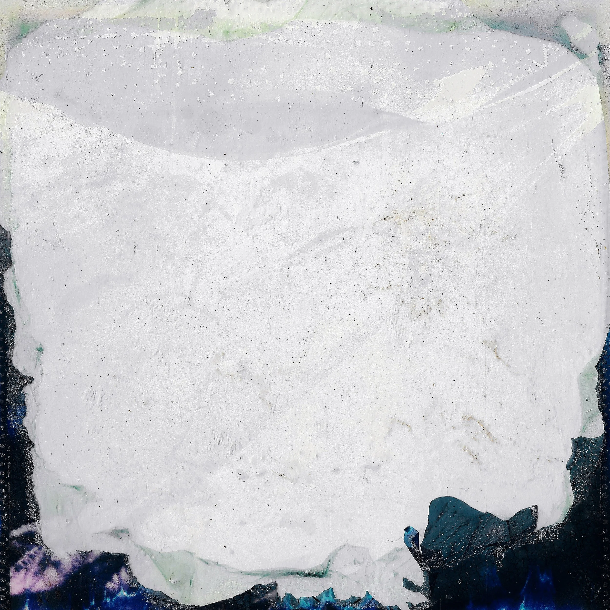 Empty torn piece of white paper with rough edges against dark background.