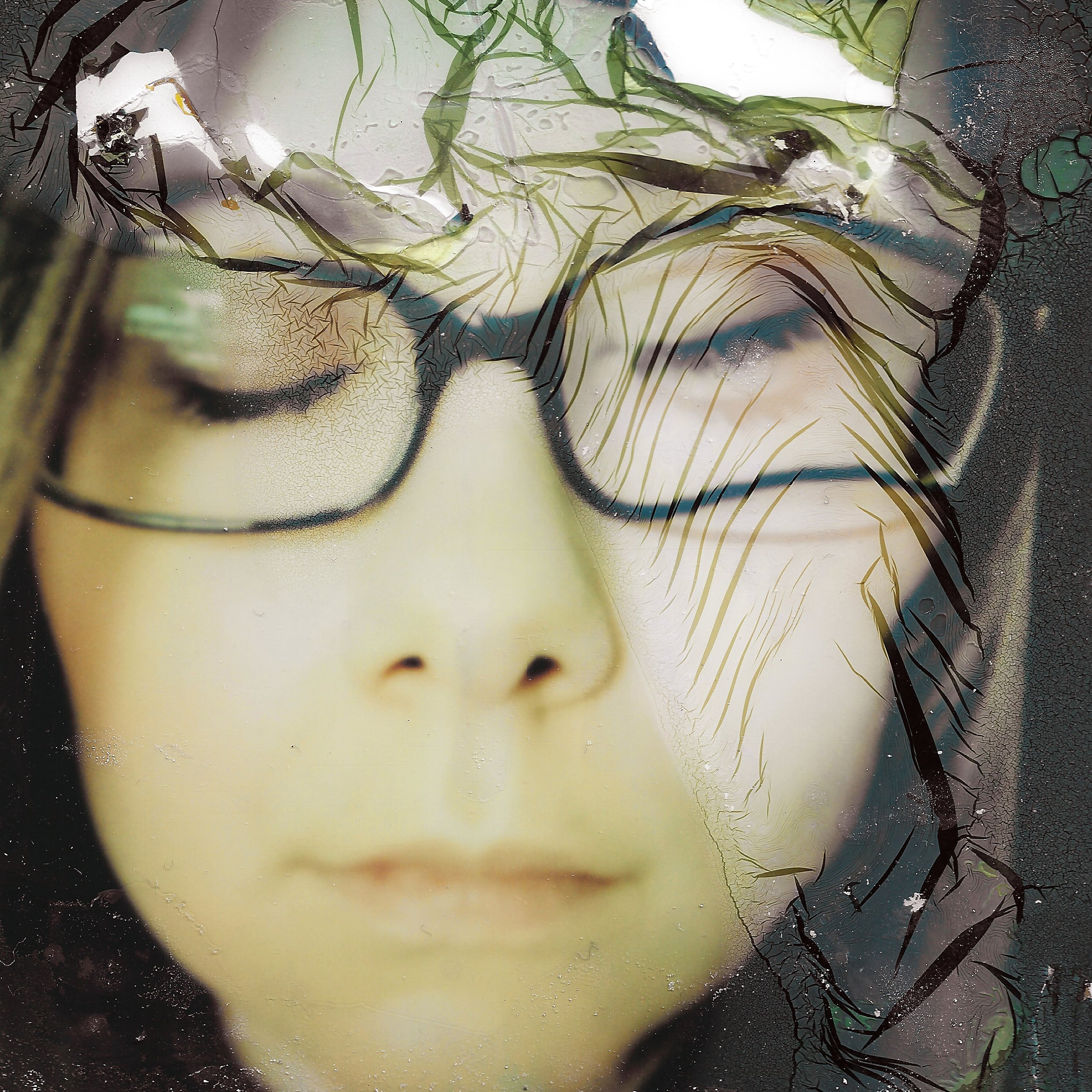 Close-up of a doll's face with glasses, with cracked, peeling paint and reflections overlaying the face.