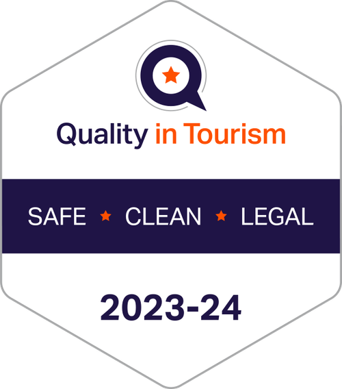 Badge for Quality in Tourism featuring a magnifying glass with a star, promoting safe, clean, and legal tourism for 2023-24.
