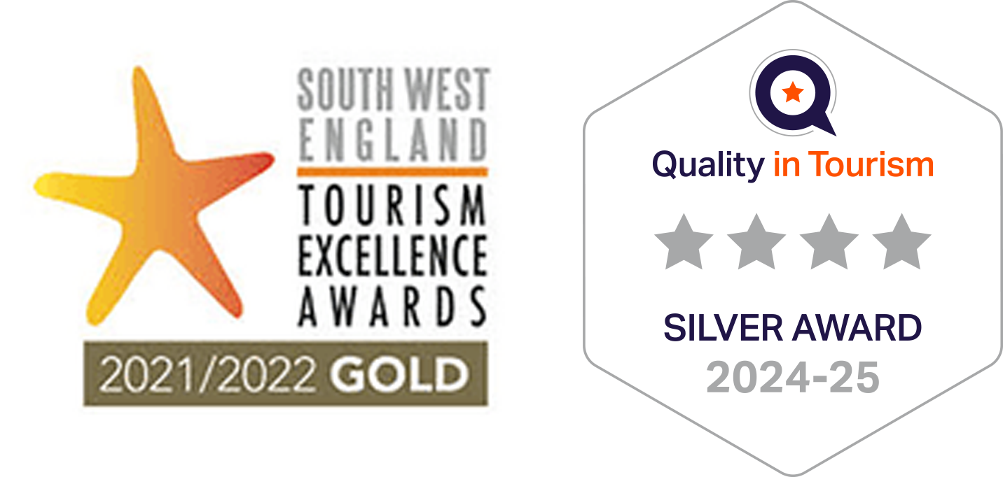 Gold award badge from the South West England Tourism Excellence Awards 2021/2022, featuring a star symbol, with a focus on quality in tourism, awarded as a silver award for 2024-25.