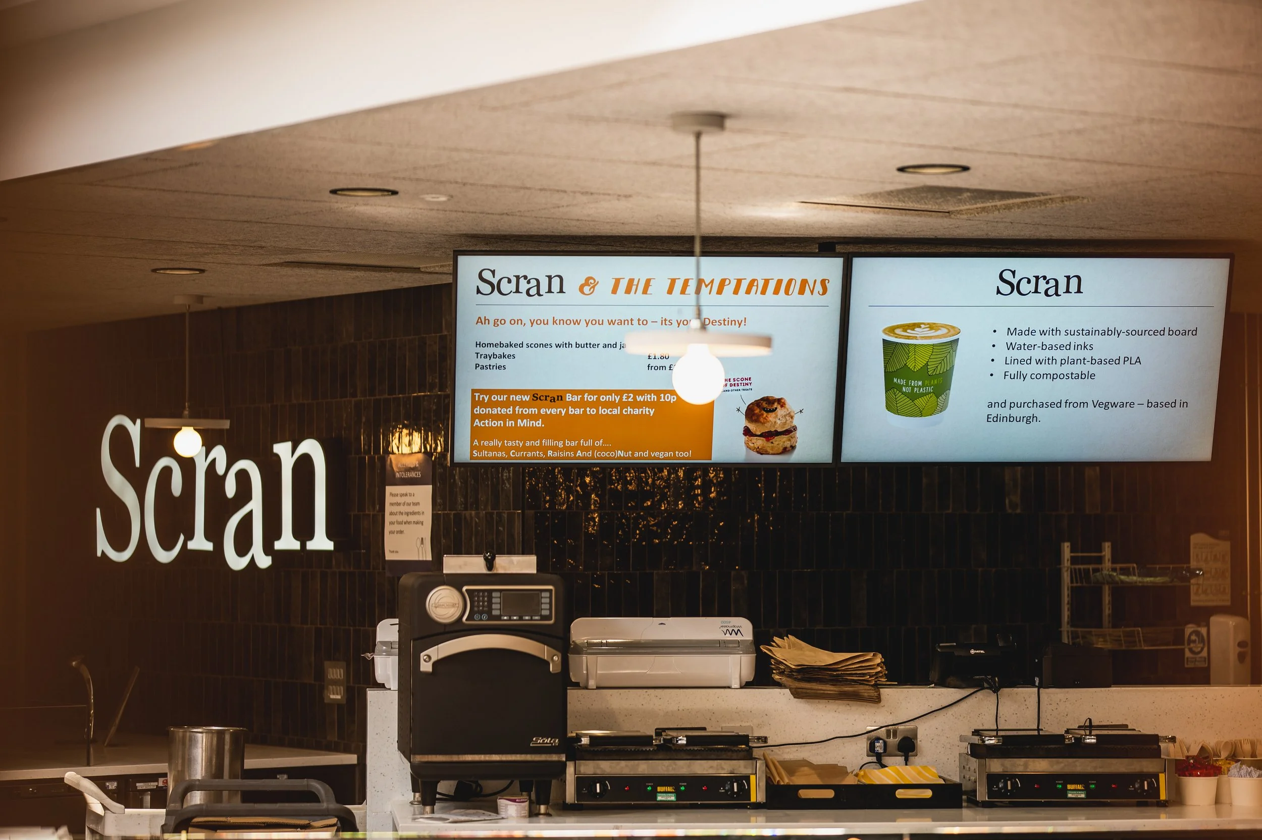 Digital menu board in a restaurant or cafe displaying food items and descriptions.