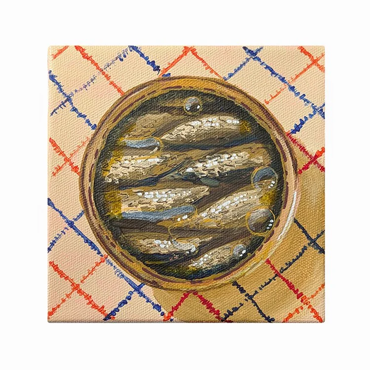 A tin of sardines on a plaid table cloth