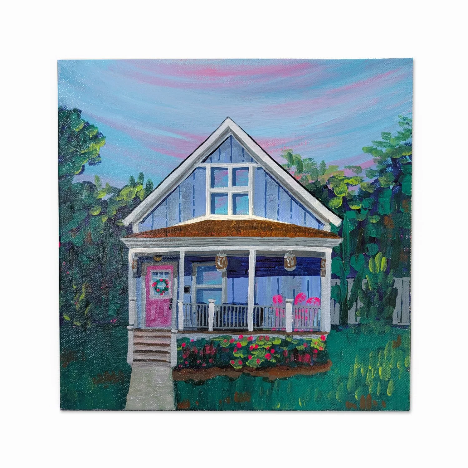 A colorful painting of a house with a porch, pink door with a wreath, pink chairs, surrounded by greenery and trees, under a pink and blue sky.