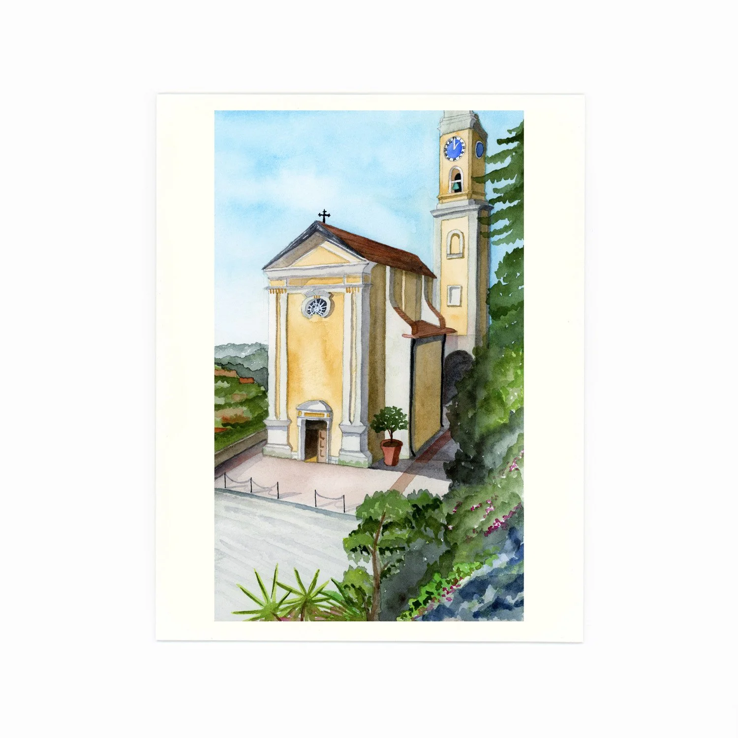 Watercolor painting of a church with yellow walls, a clock tower, and a red roof, surrounded by greenery and a paved walkway.