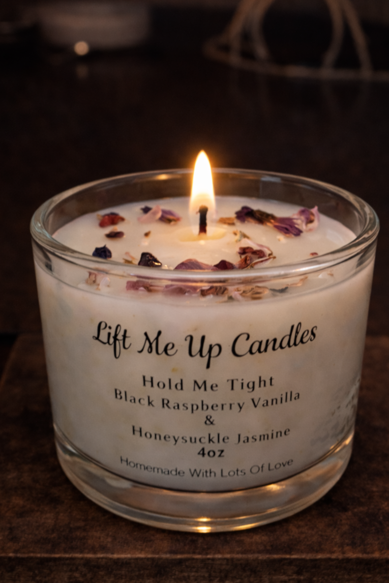 Lift Me Up Candles black raspberry vanilla and honeysuckle jasmine candle with petals.