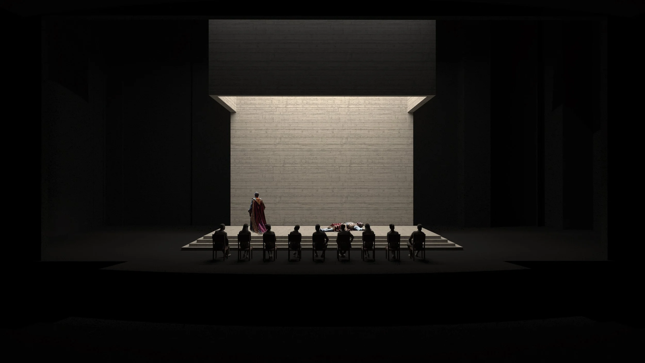 Dark theater stage with minimalist concrete background, dimly lit. A person in a cloak stands near the center where another person lies on stage. Several seated figures in the foreground, silhouetted.