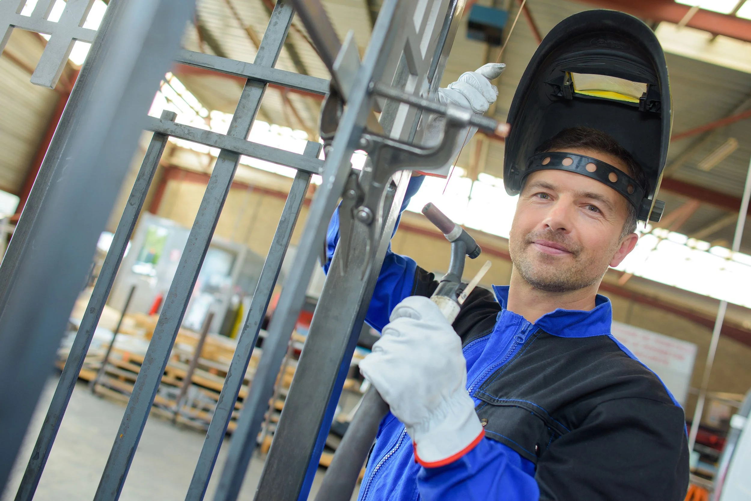 A worker wearing a welding helmet is busy at work. He doesn't have time to search for a new job, so he is looking for a welder recruiting firm that streamlines the recruiting process for hiring welders