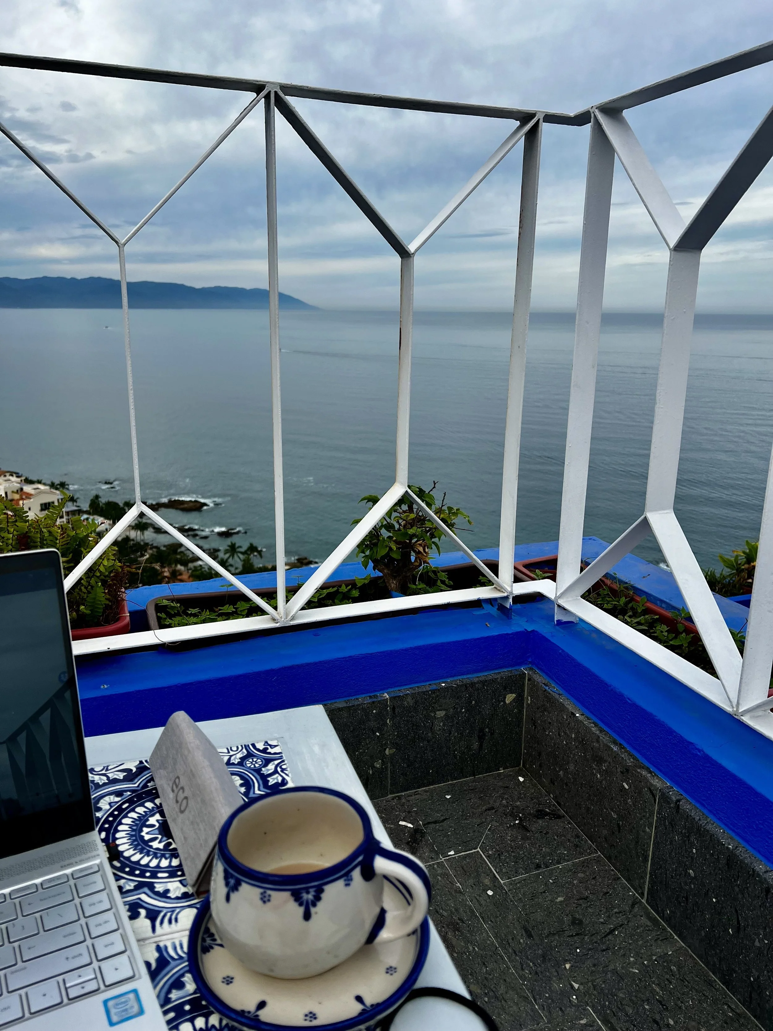 laptop on table overlooking pacific ocean