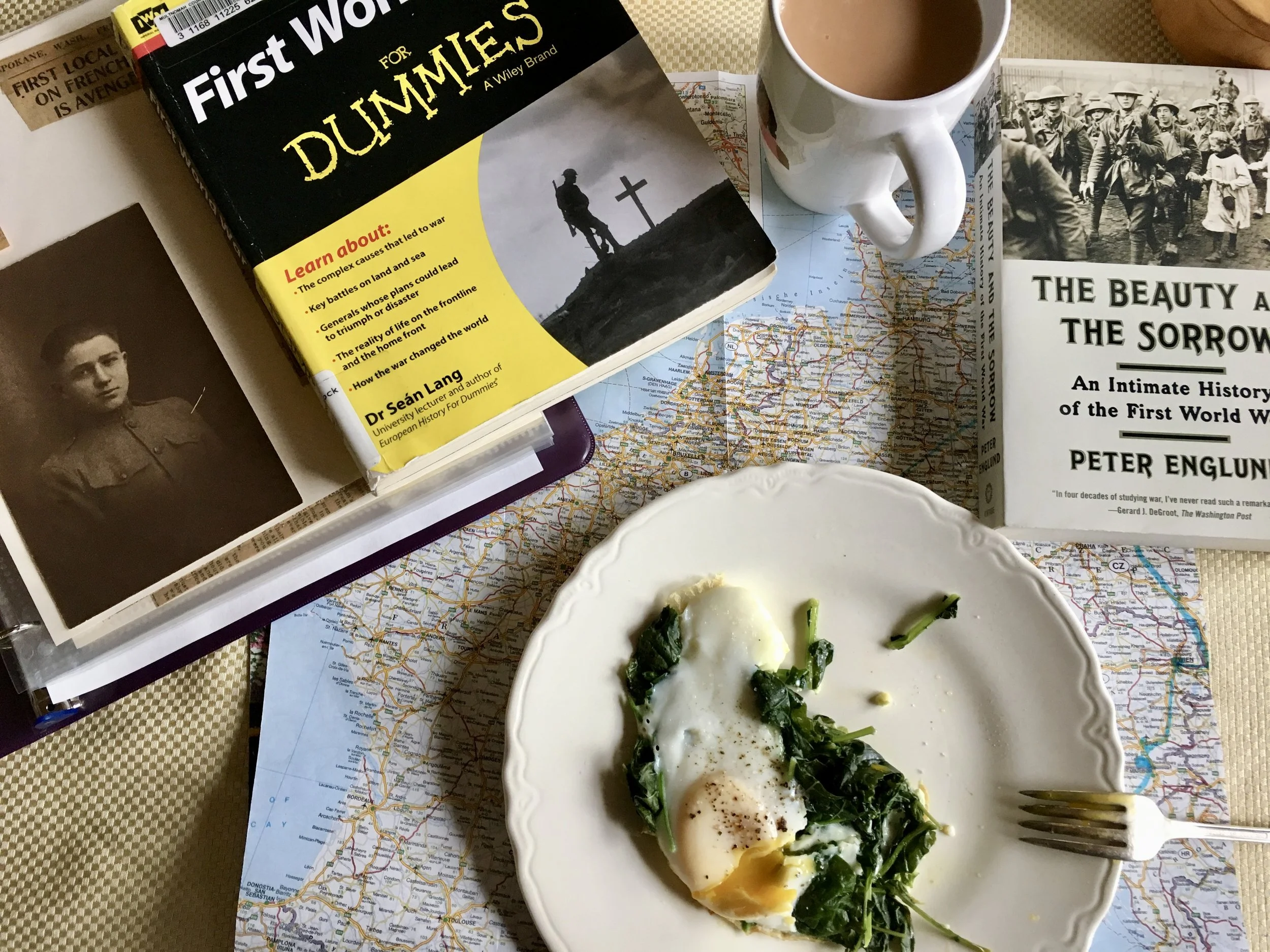 egg breakfast with map, teacup and book