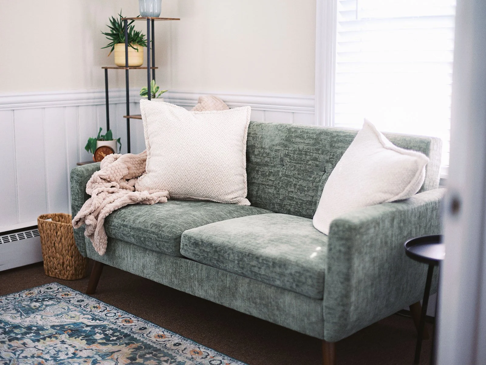 green couch with plant stand