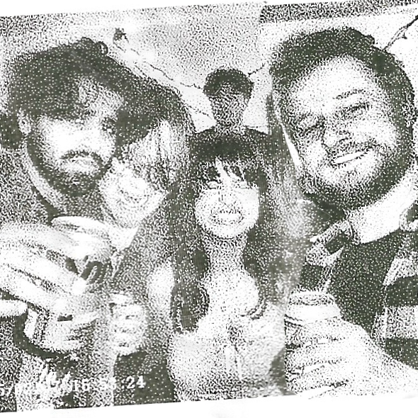 Four filmmakers smiling and holding drinks at a party or social gathering.