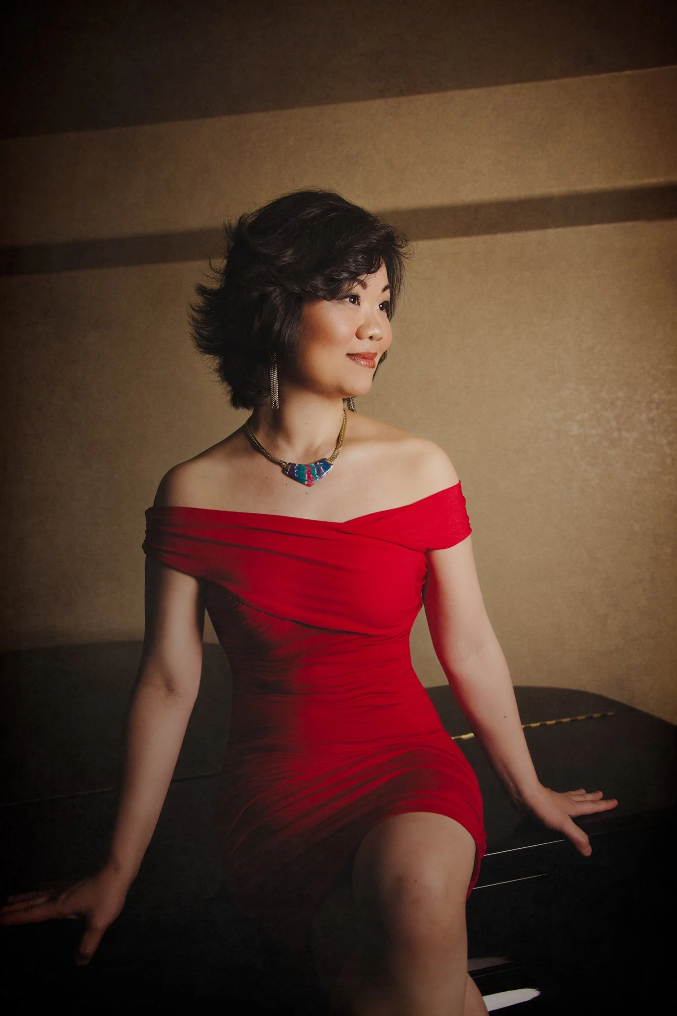 Elegant fine art portrait in red dress studio lighting