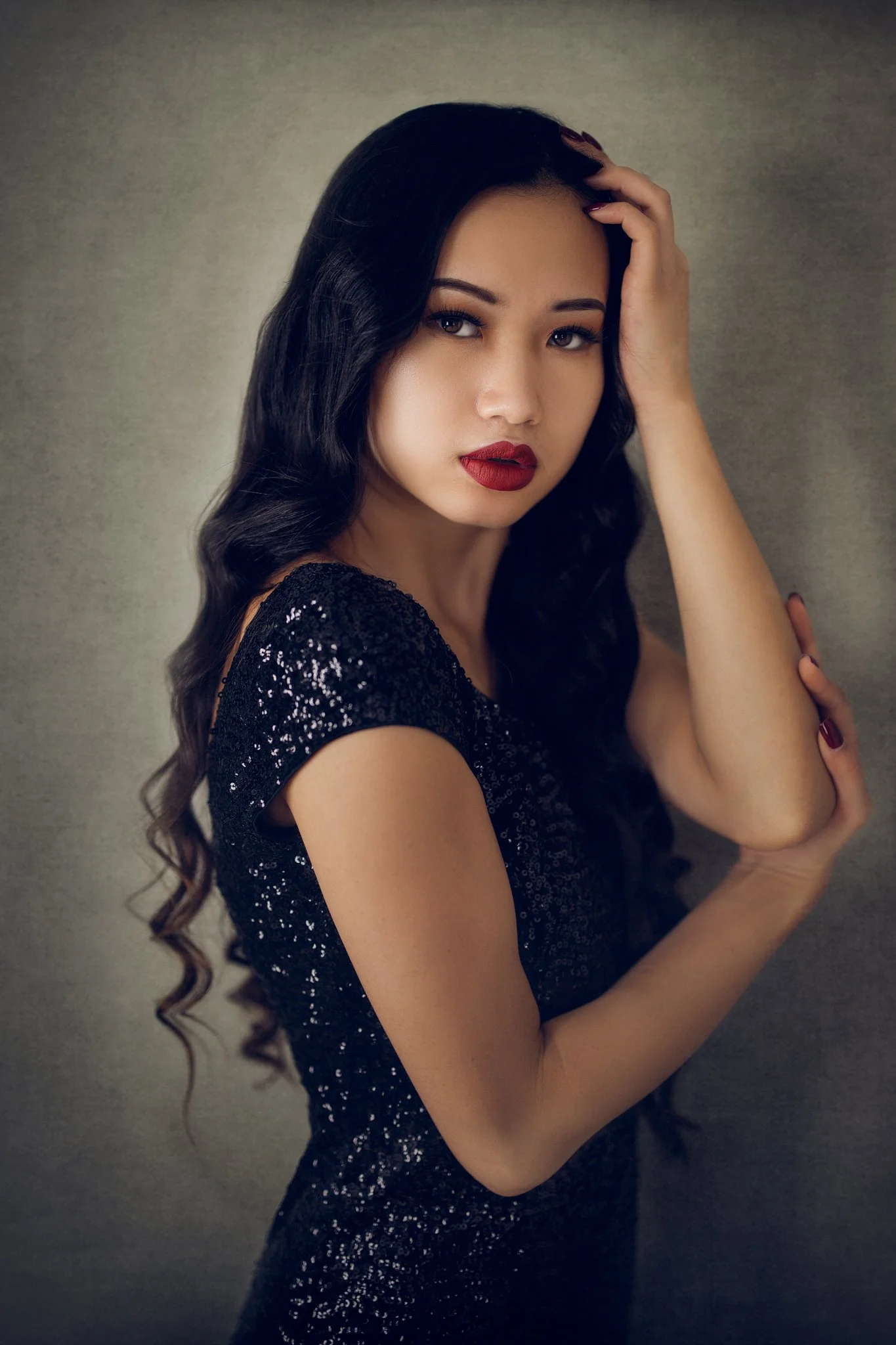 Studio fine art portrait of Asian woman in black dress