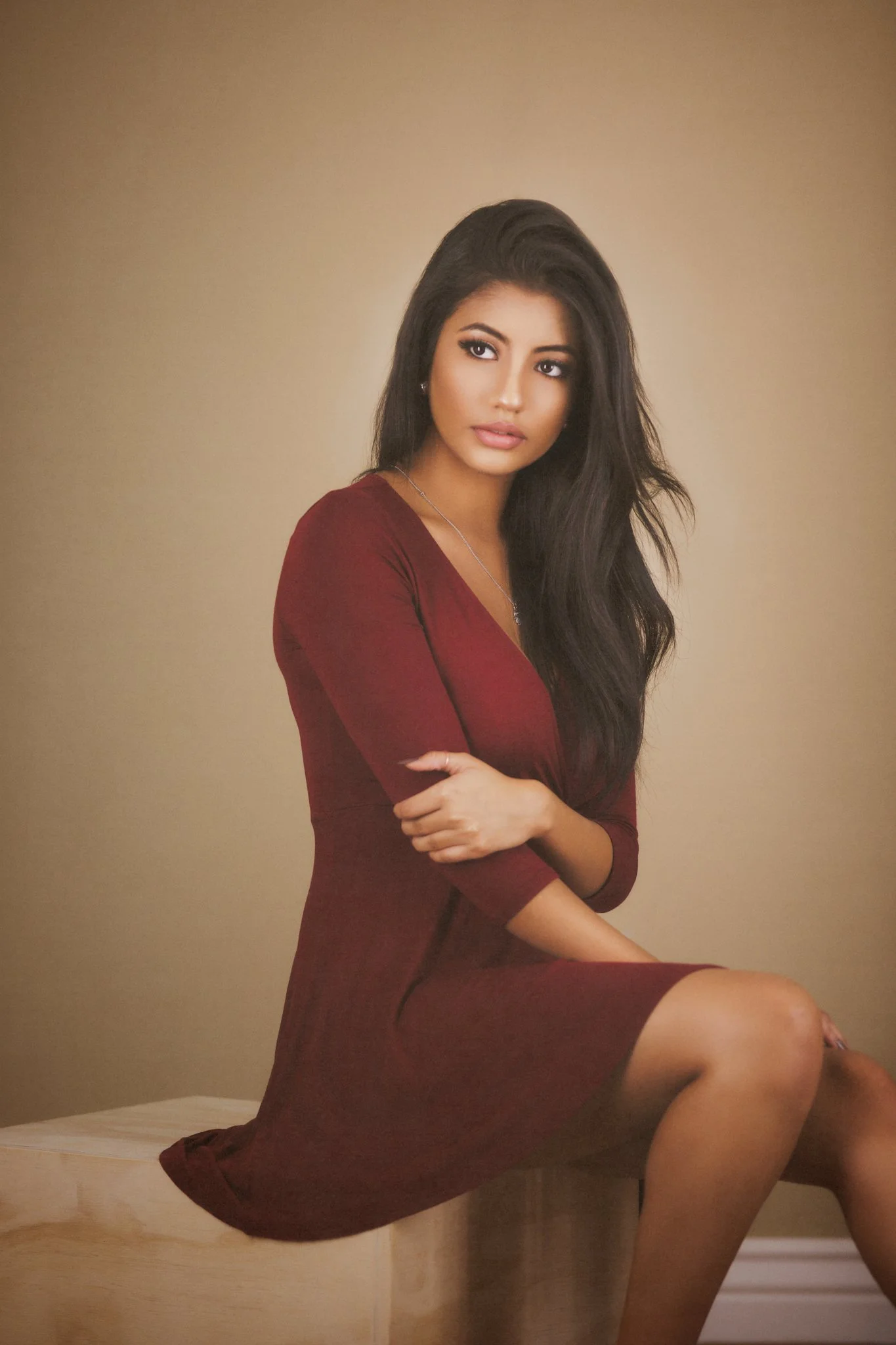 Soft natural fine art portrait seated woman beige background