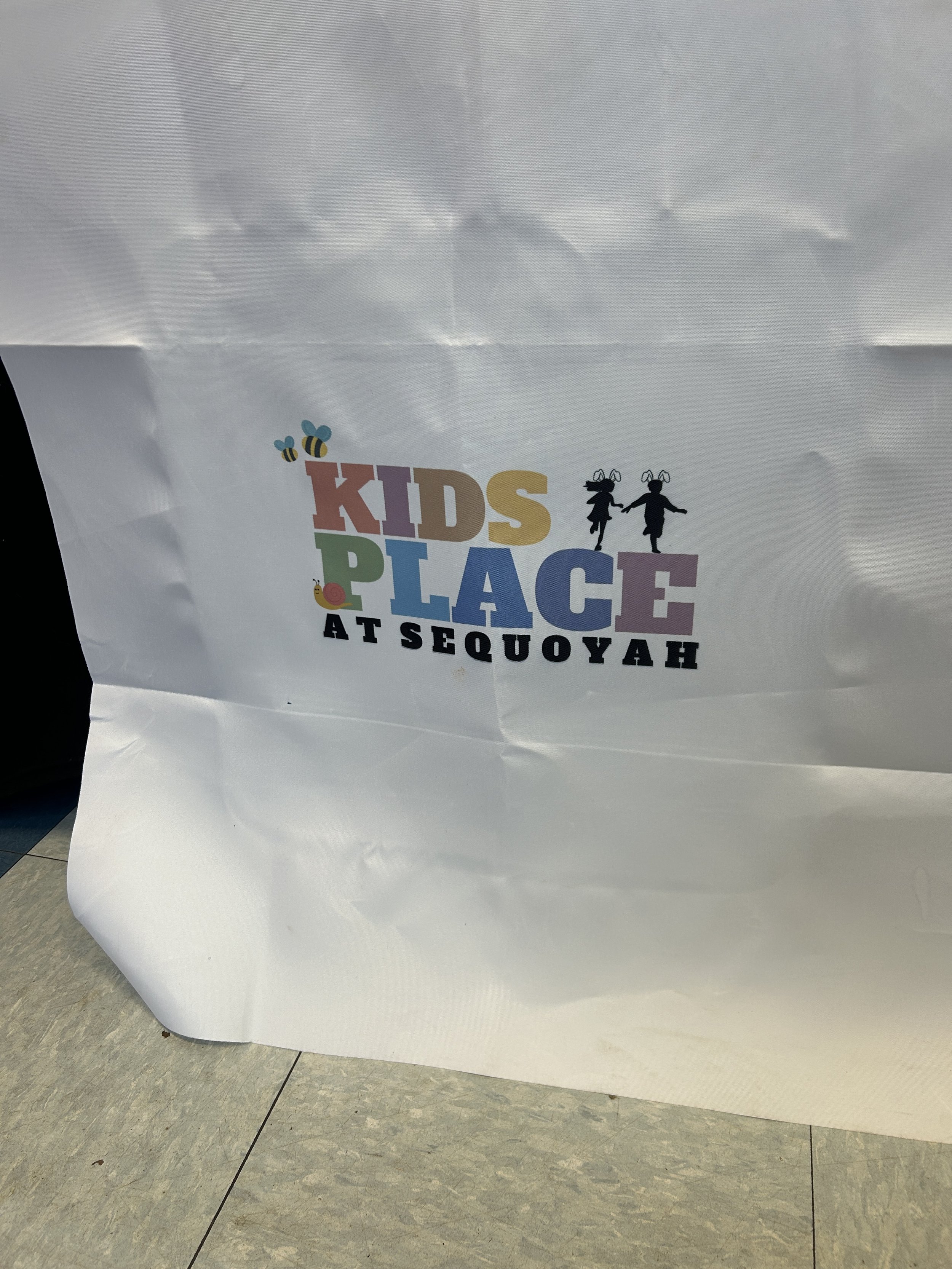 The logo displayed on a table cloth and made fun for spring
