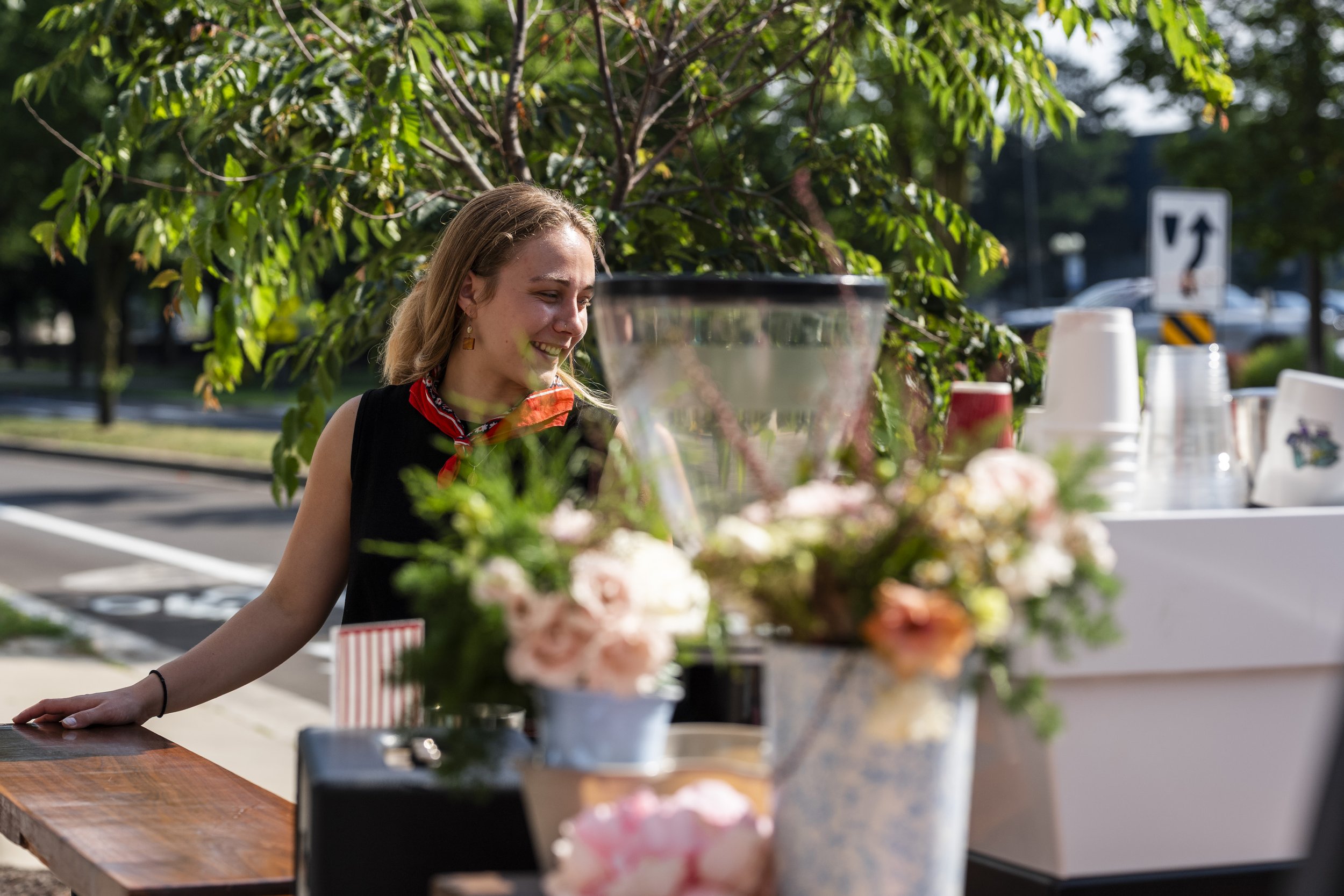 barista serving coffee next to espresso machine