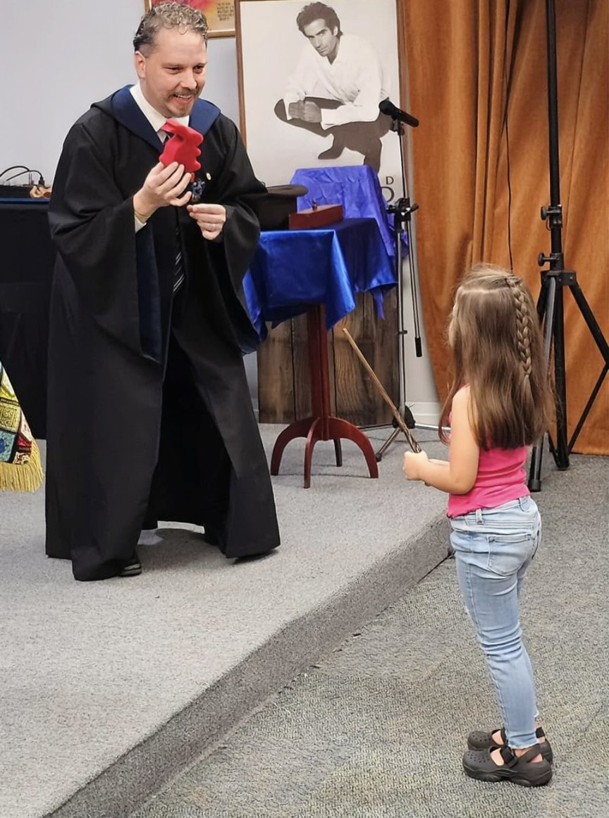 John performing at the Whittier Museum for the SAM Hall Of Fame. Holding a red sponge bunny with a child pointing a wand