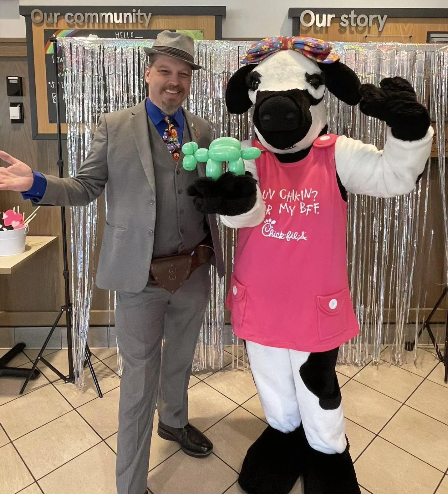 John performing at Chik Fil A, the CFA cow holds a balloon cow John made for her. 