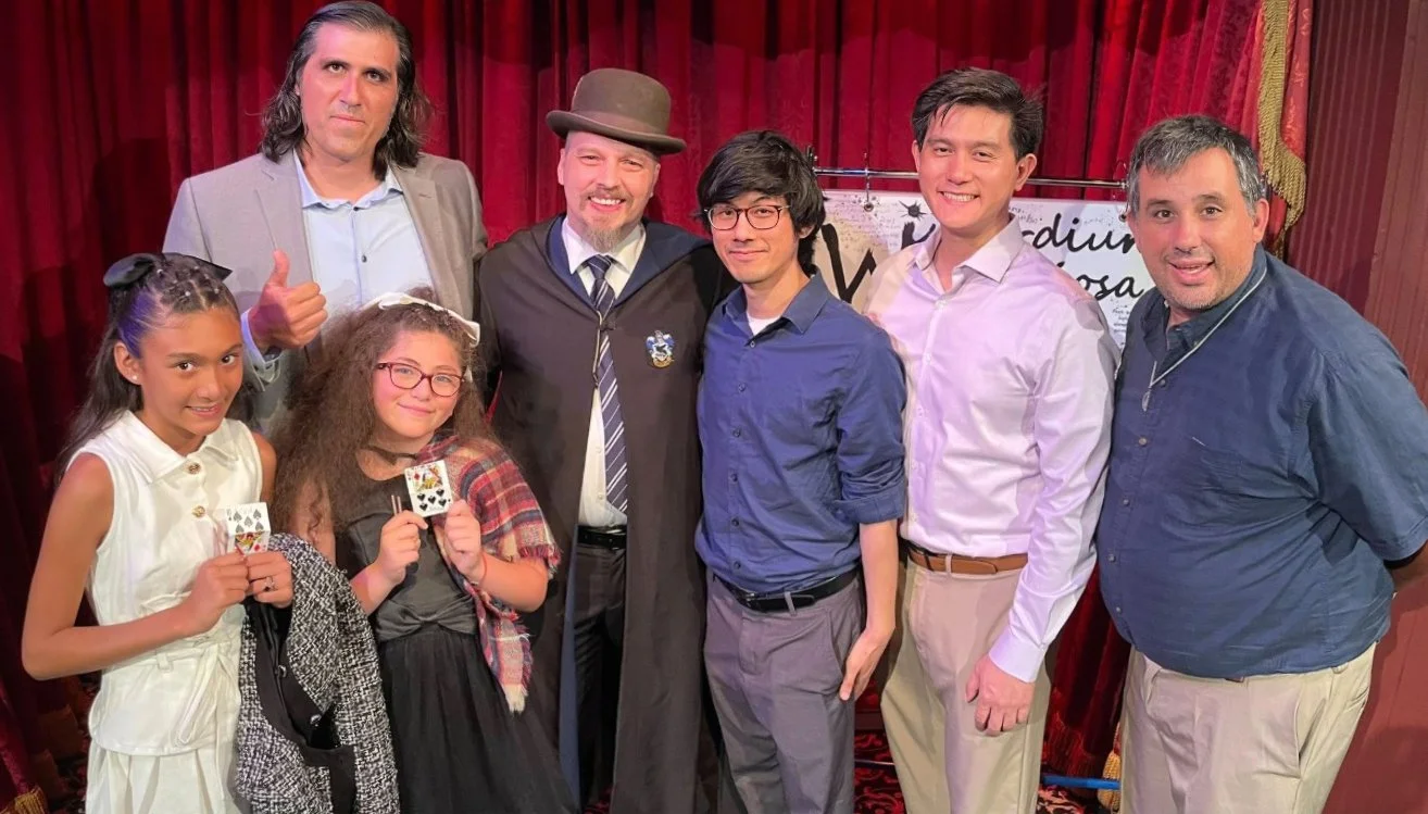 A family of friends after show at the Magic castle, two ladies hold their souvenir cards which they repaired, almost, with Reparo!