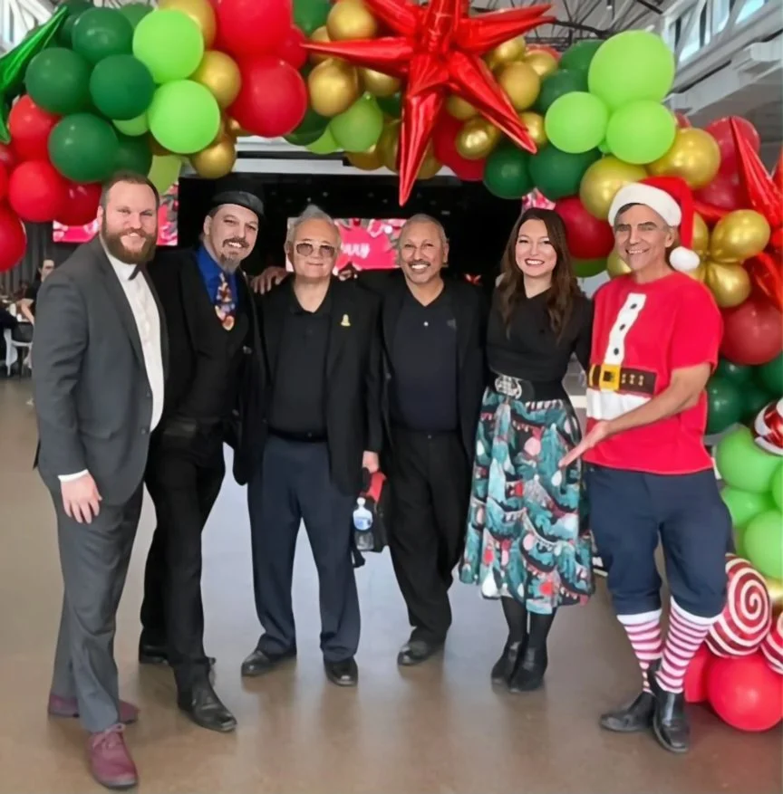 John with volunteers from the Magic Castle outreach committee performing for foster families
