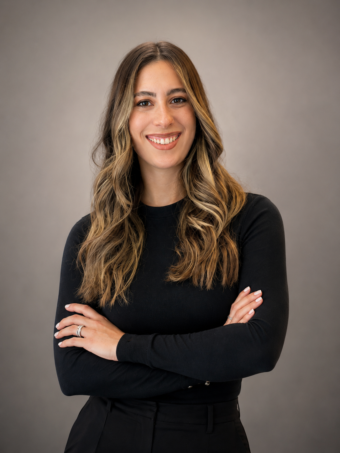 A millennial therapist located in New York, smiling with crossed arms against a neutral gray background.
Therapist provides virtual specialized therapy to millennial moms struggling with burnout and mental load