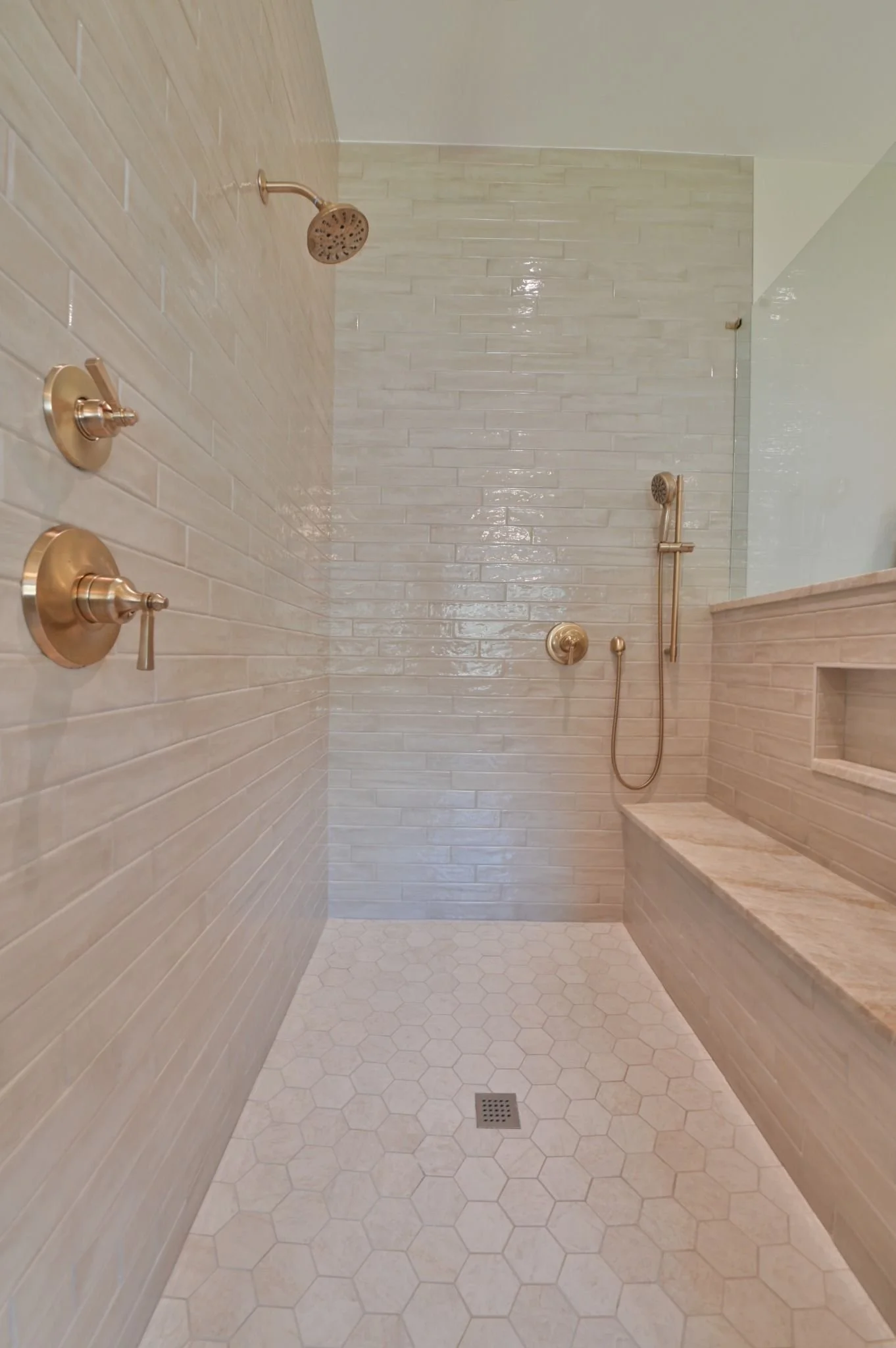 spa-inspired-walk-in-shower-with-brass-fixtures.jpg