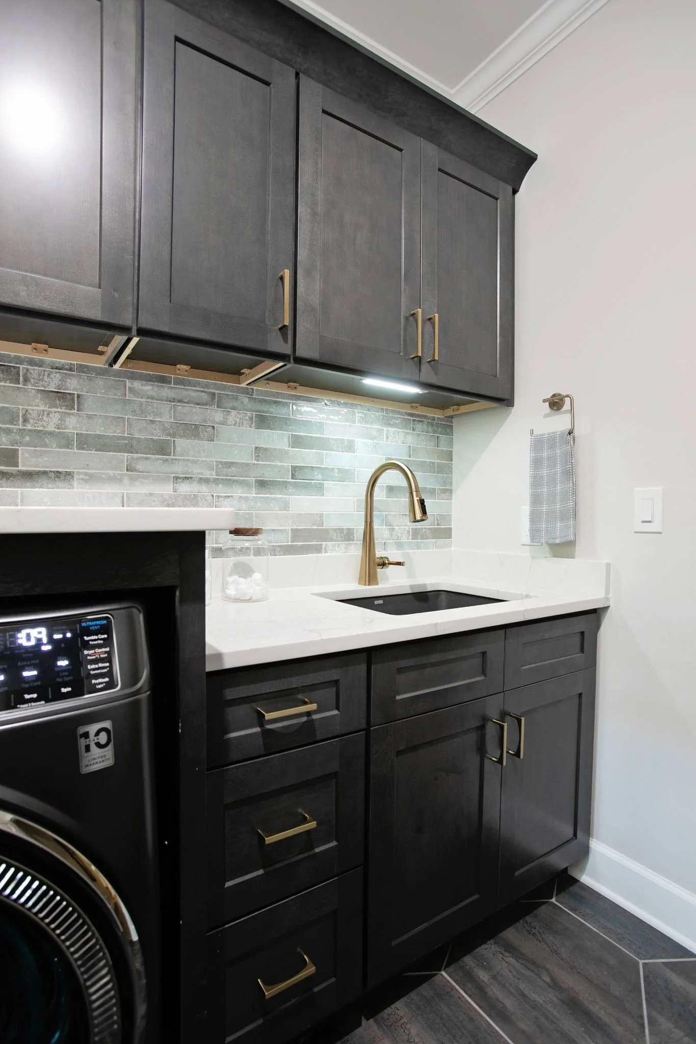modern-laundry-room-black-cabinets-tile-floor.jpg