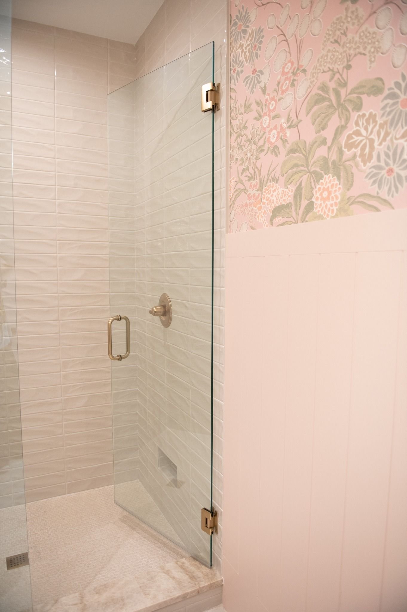 guest-bathroom-with-floral-wallpaper-and-glass-shower.jpg