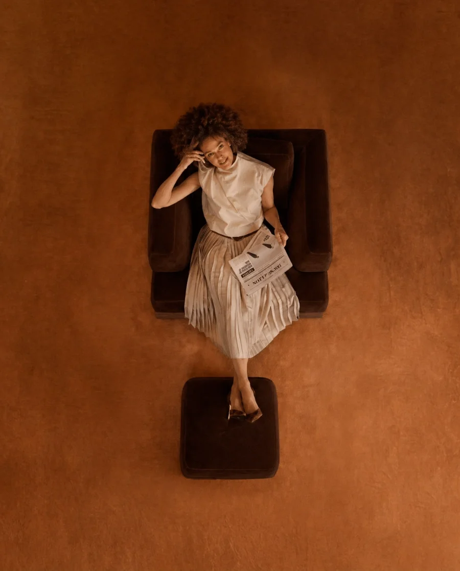 Woman seated confidently representing access, membership community and opportunities for women in business