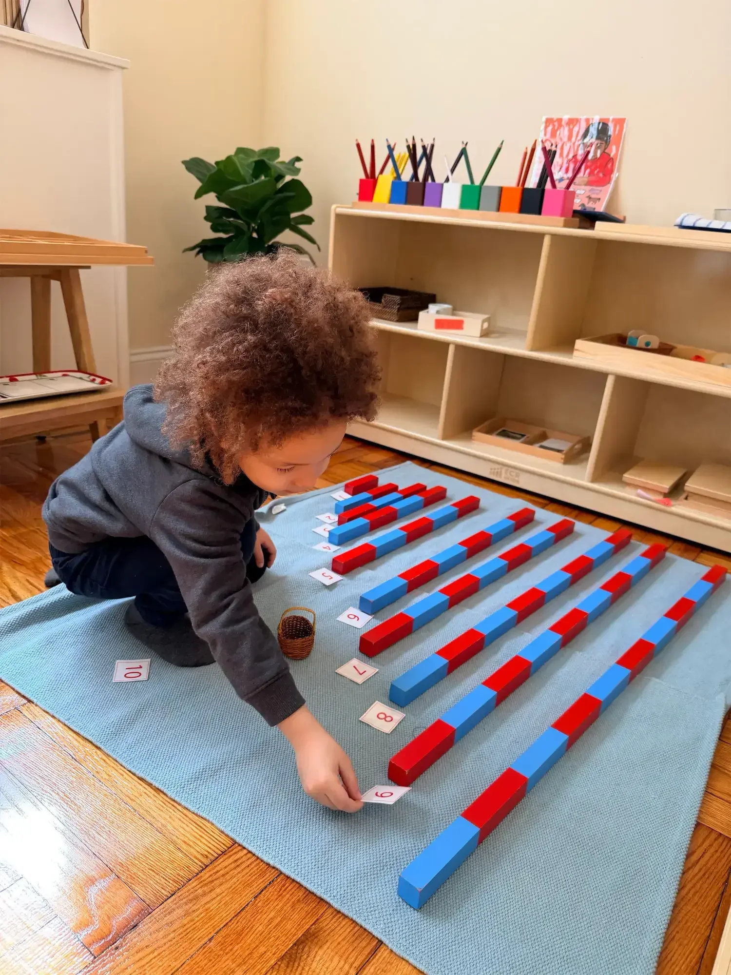 Child doing a math work at PB Too Montessori