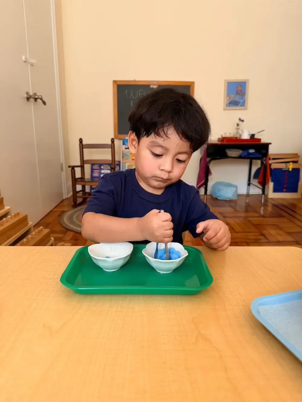 Child in Little Pathfinders doing Practice Life Work