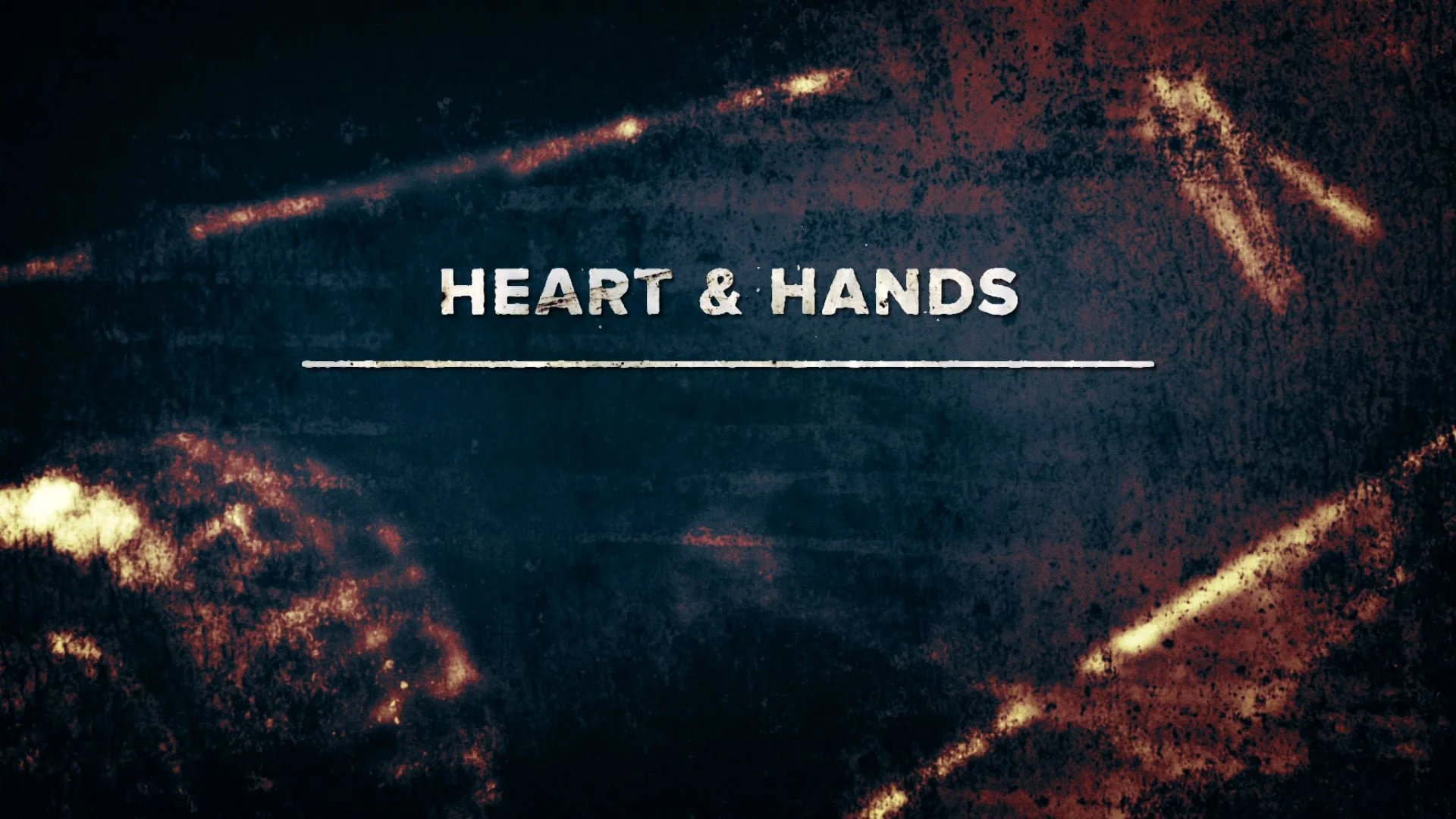 Text that reads 'Heart & Hands' over a dark, fiery abstract background.