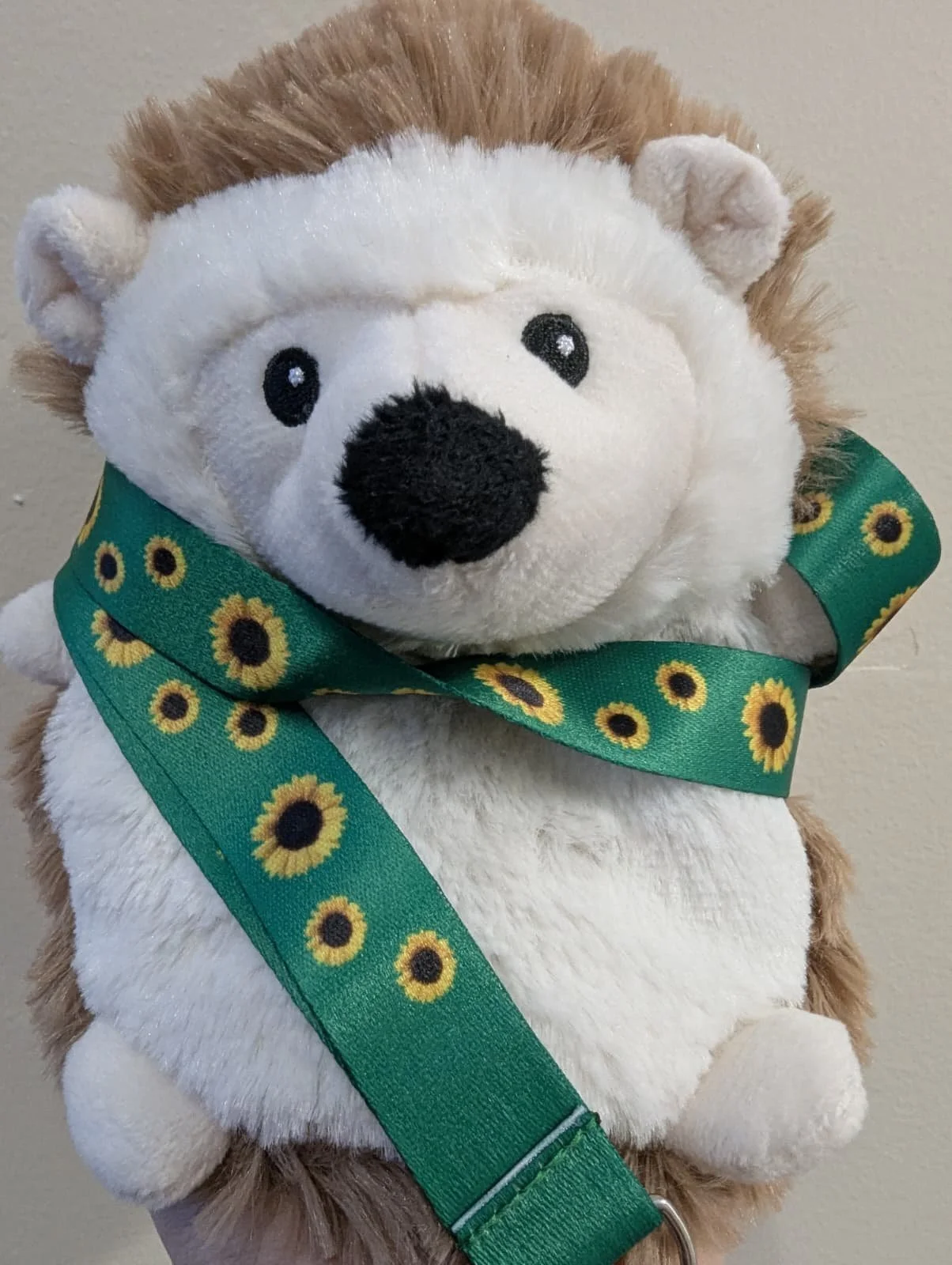 hedgehog wearing sunflower scheme lanyard