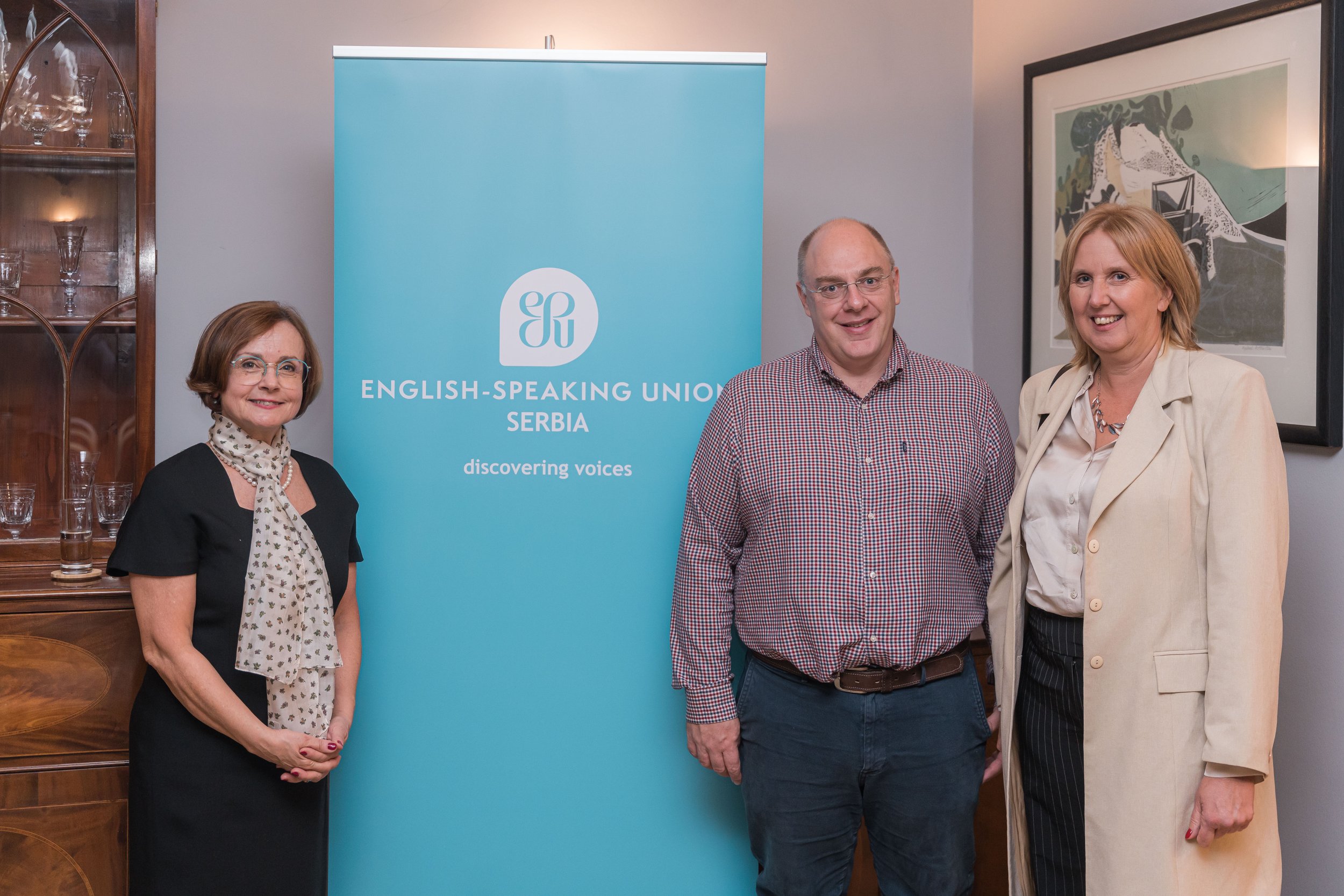 Sladjana Pavlović, ESU Serbia Chairperson, with Jonathan Pendlebury, Head of ESU NPSC Selection Board, and Aleksandra Marković, ESLI Serbia NPSC Coordinator, standing beside ESU Serbia banner.