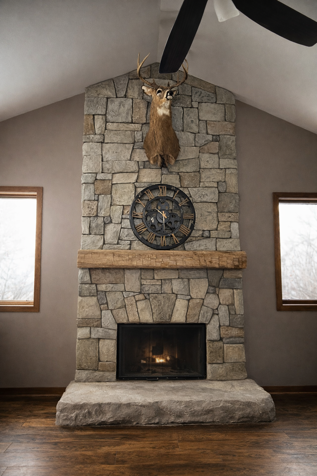 Rustic stone fireplace with deer mount.png