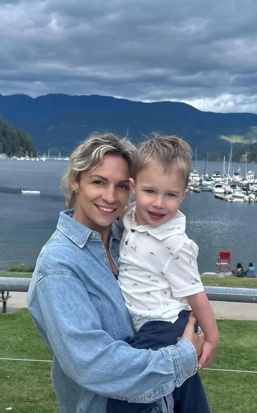 Pediatric sleep consultant Szilvia holding her toddler outdoors