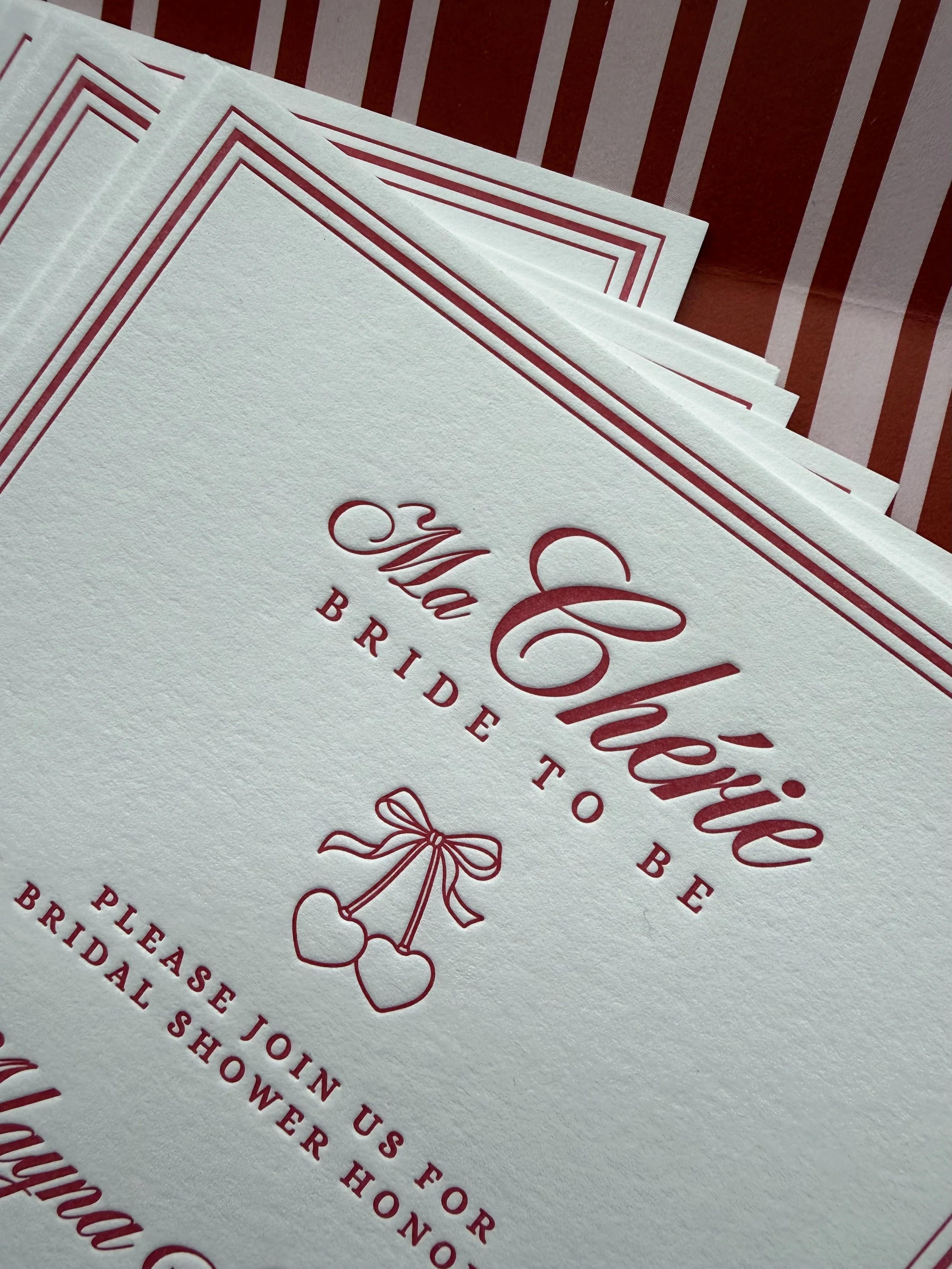 Paige & Press Custom Experience cherry-inspired bridal shower invitation featuring letterpress printing, red pinstripe details, and classic typography for an elegant celebration.