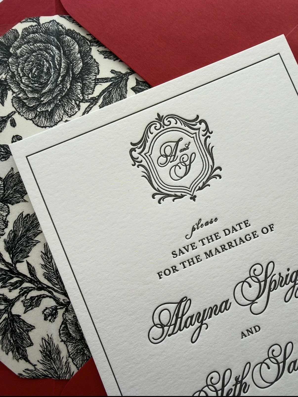 Paige & Press Custom Experience luxury letterpress save the date featuring a custom wedding crest, floral envelope liner, and timeless black typography by Paige & Press.