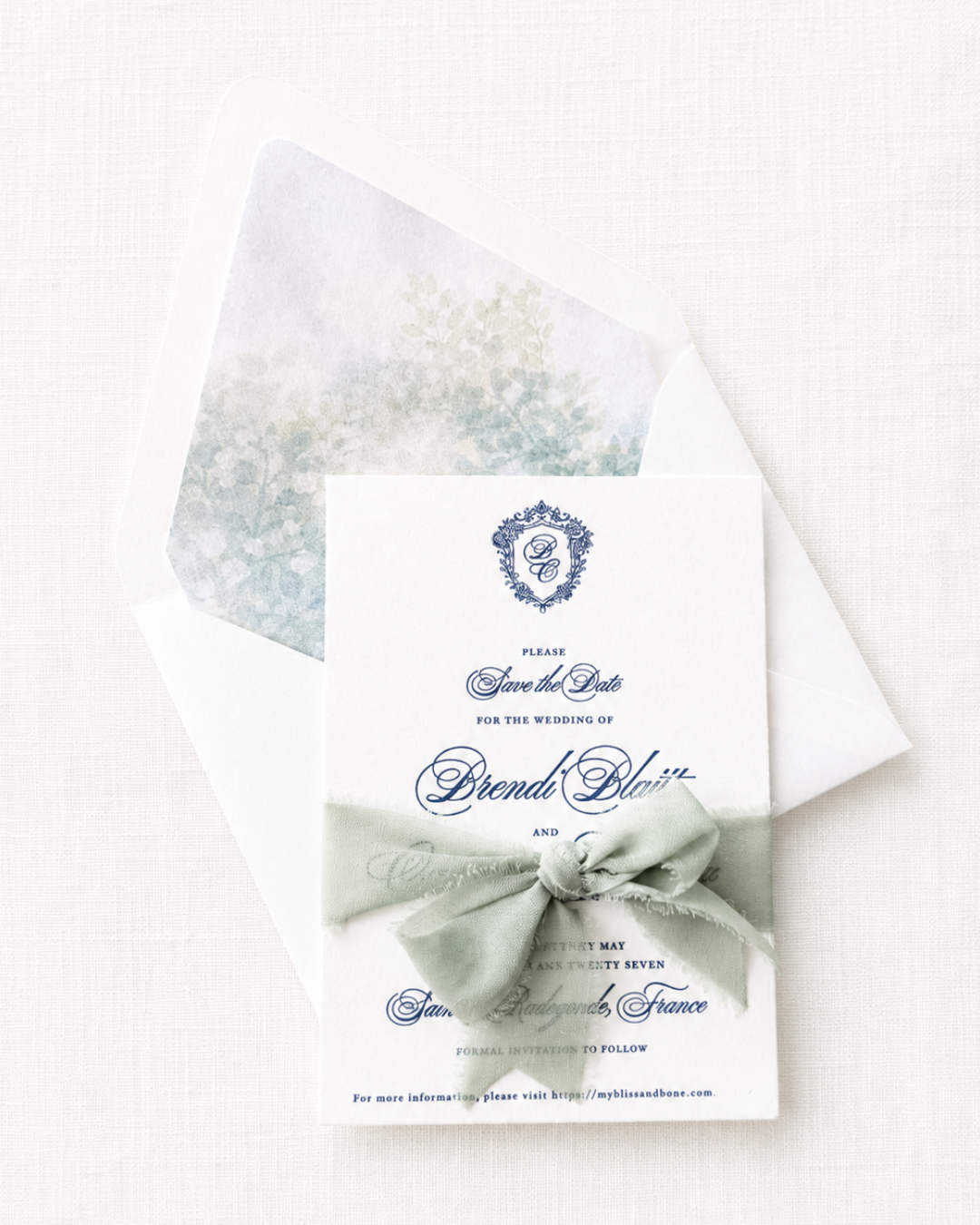 Paige & Press Custom Experience letterpress wedding invitation save the date featuring sage chiffon ribbon, floral envelope liner, and heirloom finishes.