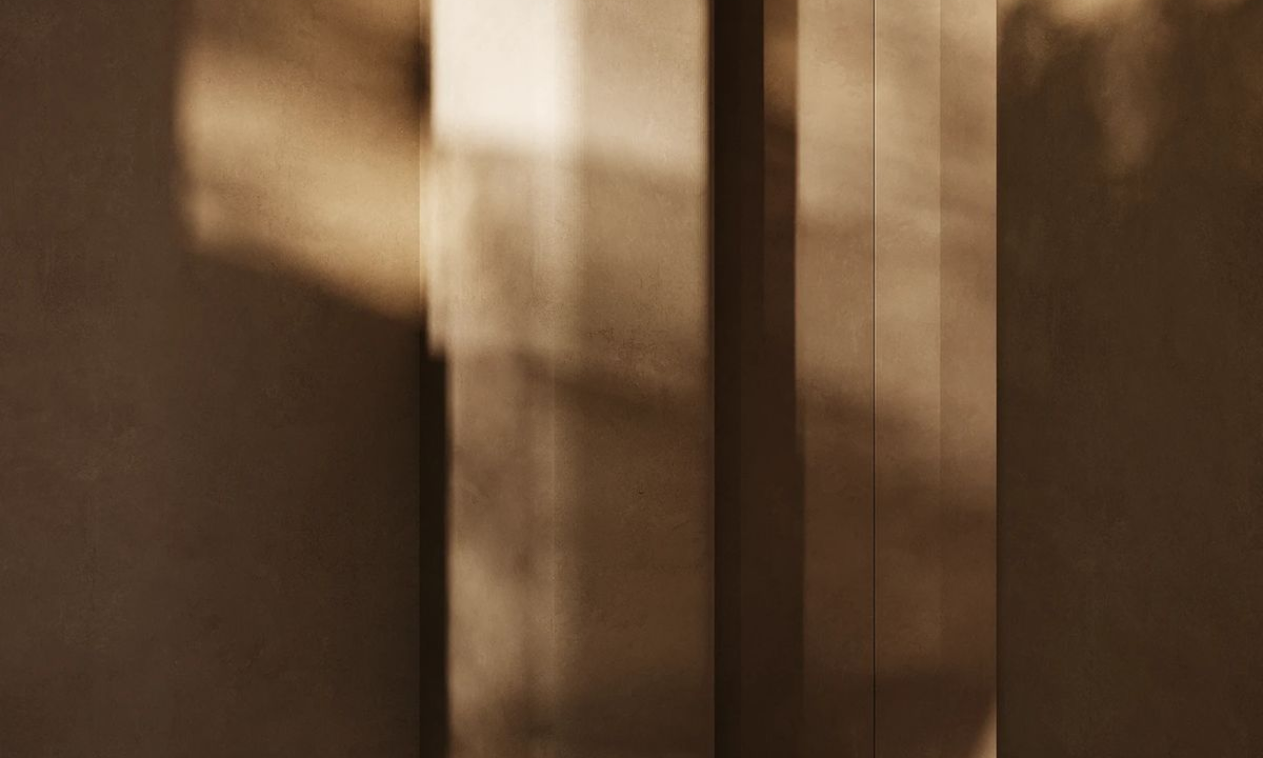 A close-up of neutral textured surface with shadows.