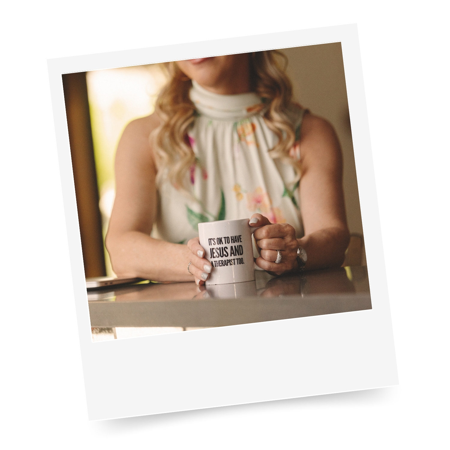 Polaroid of Sarah holding a mug with "It's okay to have Jesus and a therapist too" printed on