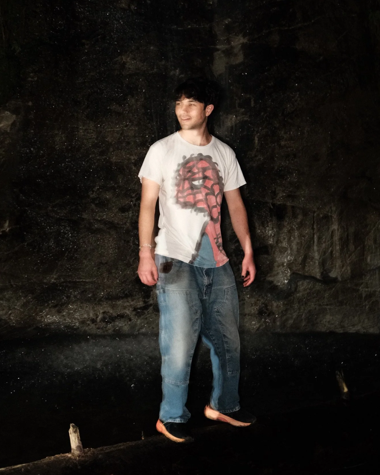 Picture of Mark Menz, the creator of the Beyond Drawings YouTube Channel, taken in Santa Cruz California. Next to a waterfall at night, it shows Mark posing with a spray painted Spider-Man shirt.